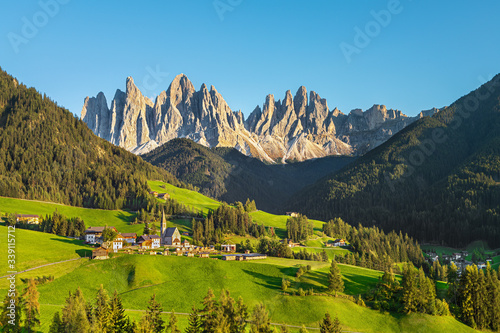 Famous alpine place Santa Maddalena village with magical Dolomites mountains in background, Val di Funes valley, Trentino Alto Adige region, Italy