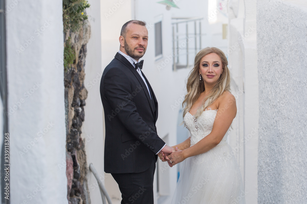Happy wedding couple walking and posing on old streets
