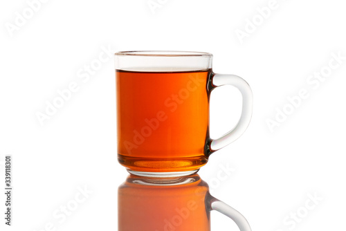 glass Cup of tea on a white isolated background with a shadow on the table