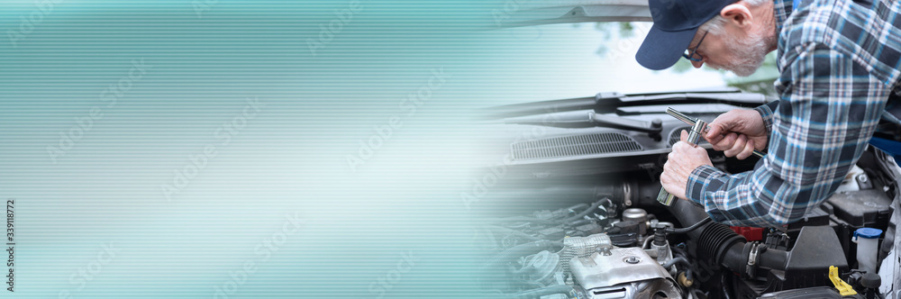 Car mechanic working on car engine; panoramic banner Car mechanic working on car engine; panoramic banner