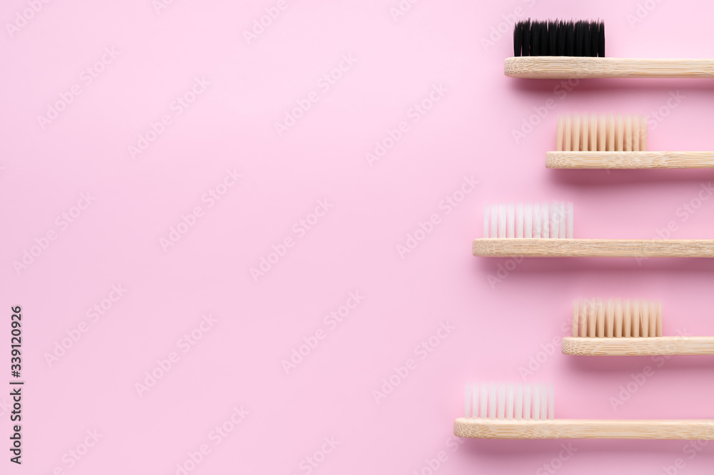 Zero waste and no plastic concept. Group of eco natural bamboo toothbrushes on a pastel pink surface. Flat lay, copy space, horizontal orientation. Zero waste and no plastic concept. Group of eco natural bamboo toothbrushes on a pastel pink surface. Flat lay, copy space, horizontal orientation.