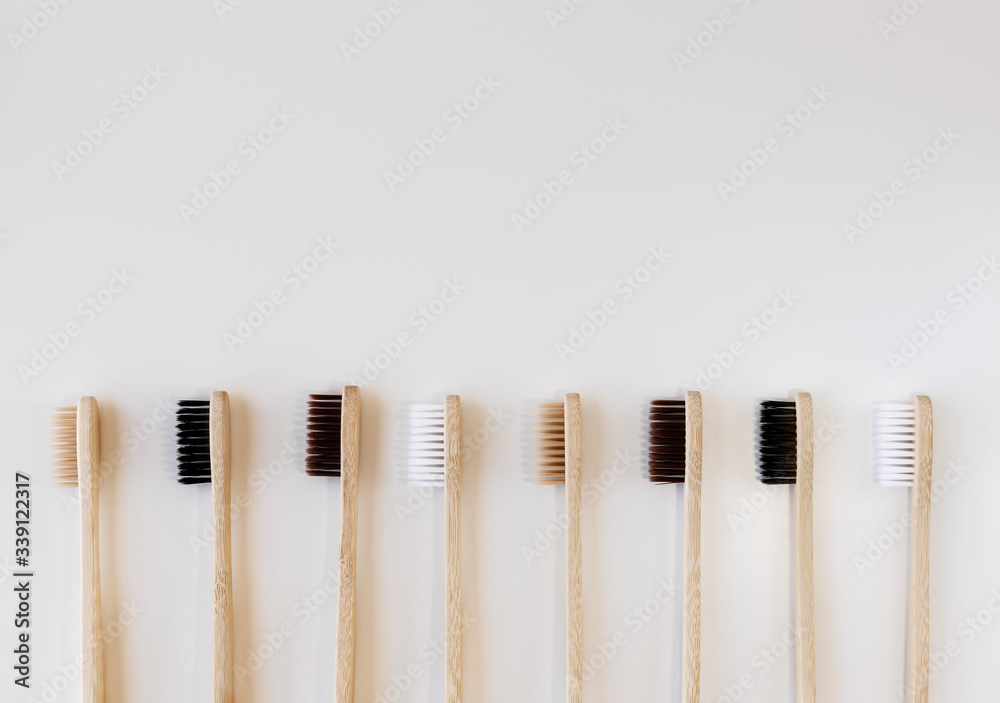 Group of eco bamboo toothbrushes, on white background. Different color. Top view, copy space. Natural organic product for oral hygiene. Dental zero waste and no plastic concept. Safe for the earth. Group of eco bamboo toothbrushes, on white background. Different color. Top view, copy space. Natural organic product for oral hygiene. Dental zero waste and no plastic concept. Safe for the earth.