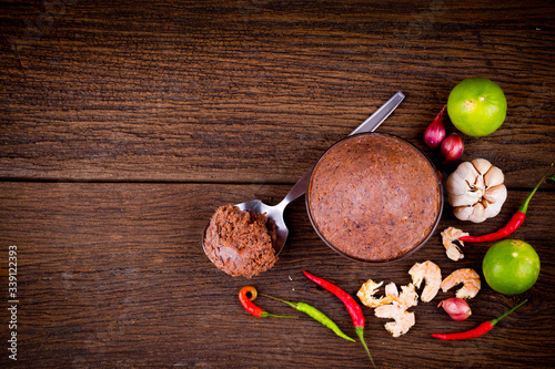 top view of Shrimp Paste ( kapi ) and thai ingredient in glass bowl on wooden background. 