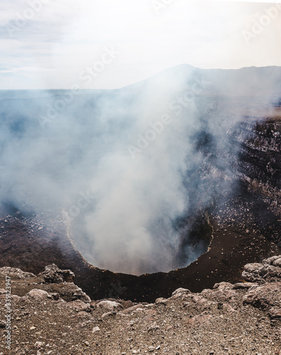 Looking down into the steaming crater of Volcan Masaya, an active volcano filled with molten lava near Granada, Nicaragua