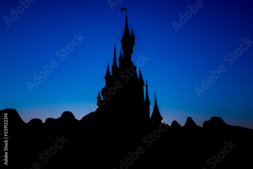 Beautiful castle with backlight and a blue background color photo