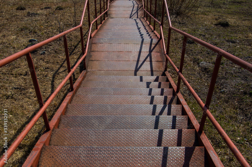 a pedestrian staircase pointing up against the sky where there are no people on the steps a pedestrian staircase pointing up against the sky where there are no people on the steps