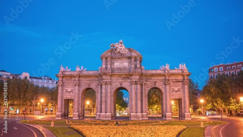 Madrid Spain time lapse 4K, city skyline night to day timelapse at Puerta de Alcala photo