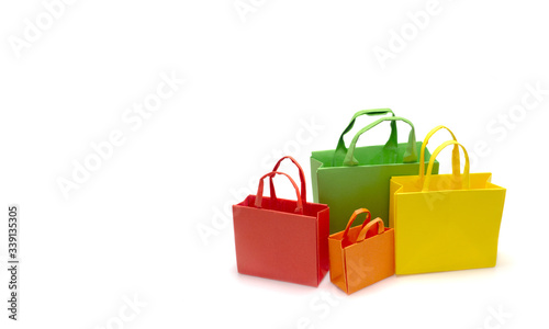 Group of colourful paper shopping bags including red, green,orange,yellow isolated on white background.Business, retail, sale and online commerce concept