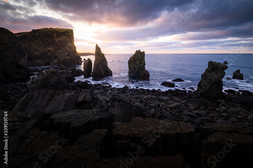 Scenic valahnukamoel volcanic rock formation at atlantic coast in Iceland during sunrise on a cloudy day