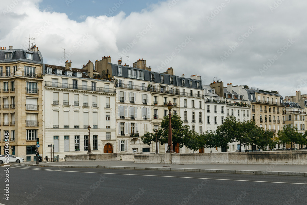 Typical old Paris architecture and deserted streets with no tourists while citizens stay at home in self isolation. Residential buildings facades, expensive real estate concept, economy crisis