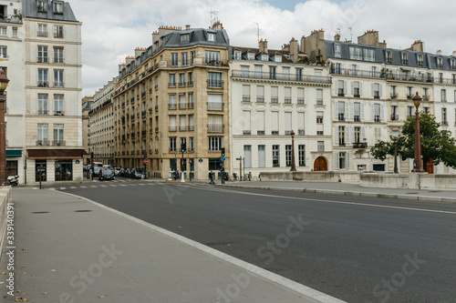 Typical old Paris architecture and deserted streets with no tourists while citizens stay at home in self isolation. Residential buildings facades, expensive real estate concept, economy crisis