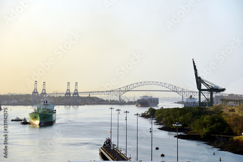 Morning panorama of the Balboa Bridge - Panama Canal. View from the transiting cargo ship. 