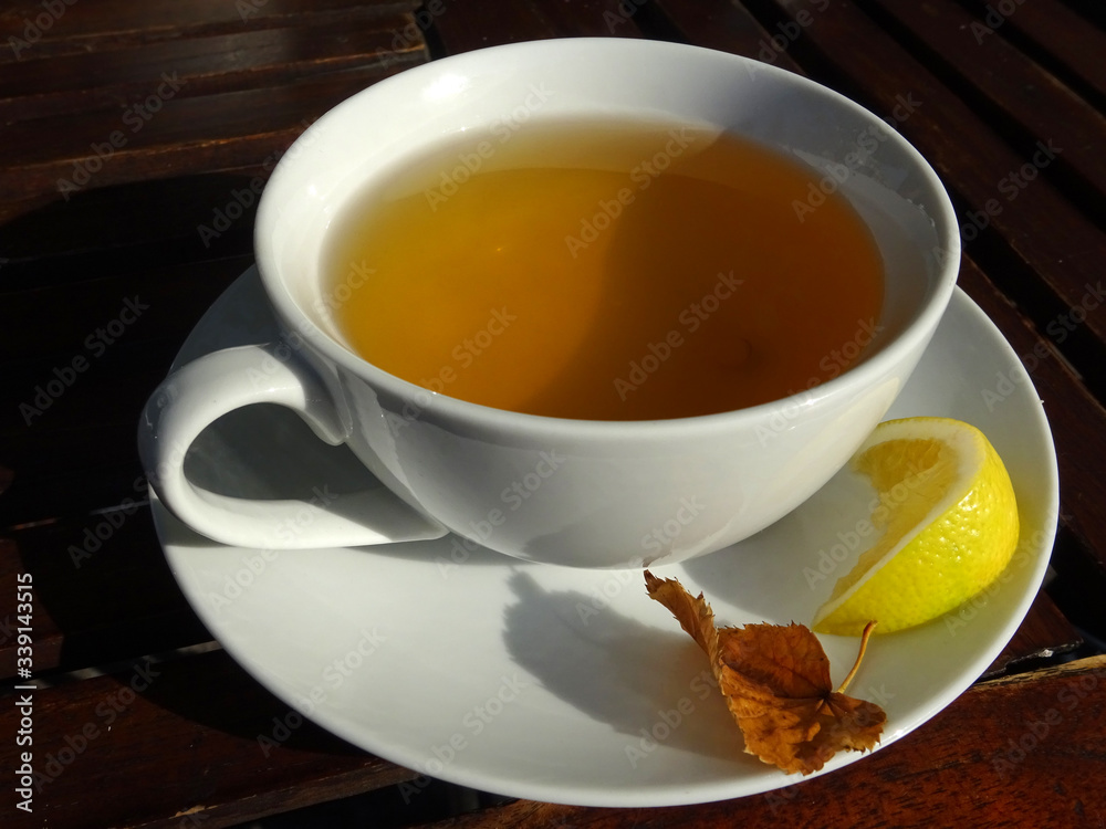 Cup of fresh herbal tea and lemon close up. Cup of fresh herbal tea and lemon close up.