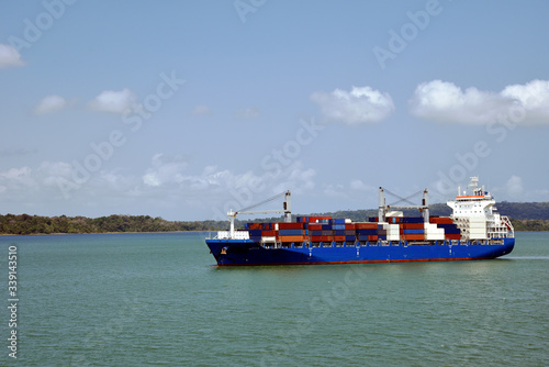Geared container ship transiting through Panama Canal on her international trade route. 