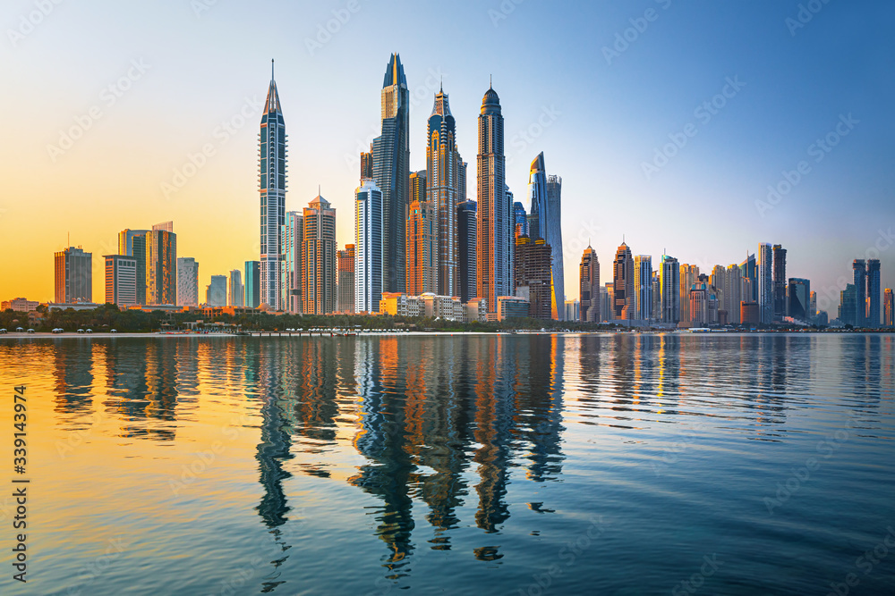 Modern and Luxury Dubai Marina with reflection - famous Jumeirah beach at sunrise, United Arab Emirates