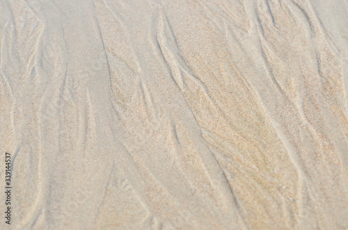 Sand along the sea is a blurred patterned background.