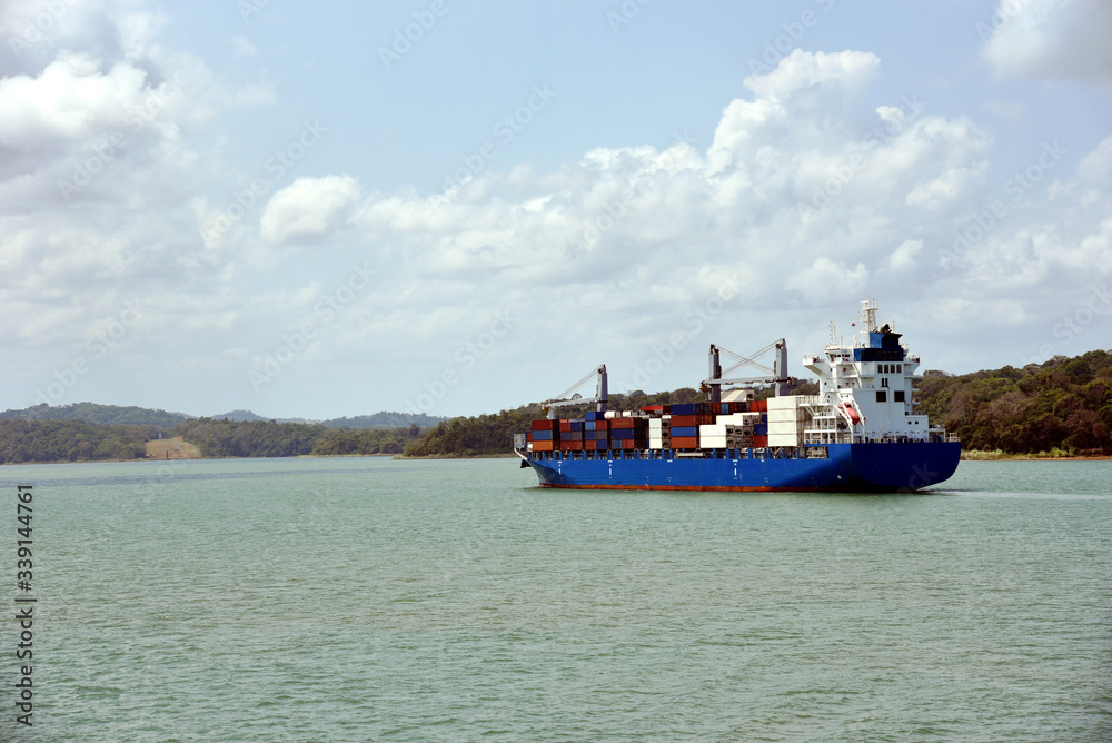 Geared container ship transiting through Panama Canal on her international trade route. 