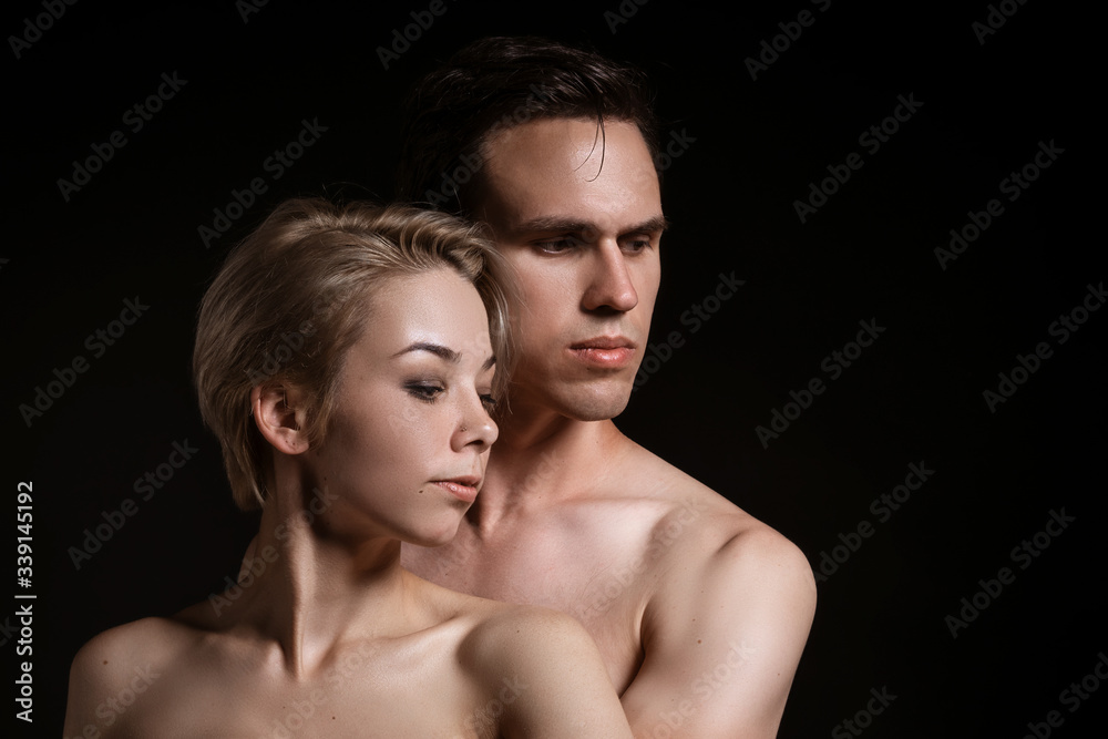 Guy and girl hugging, naked torso on a black background Guy and girl hugging, naked torso on a black background