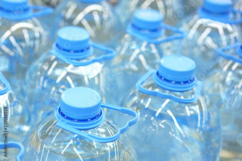 Five-liter bottles of drinking water close-up  soft focus
