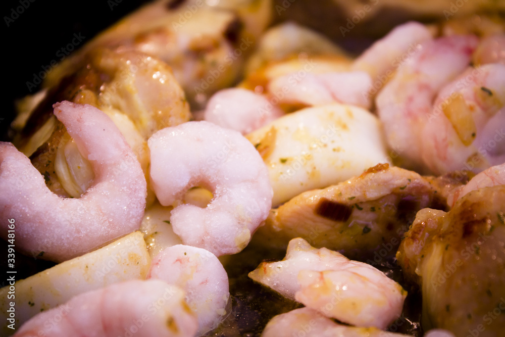 Vegetable stir fry with seafood and chicken to prepare paella Vegetable stir fry with seafood and chicken to prepare paella