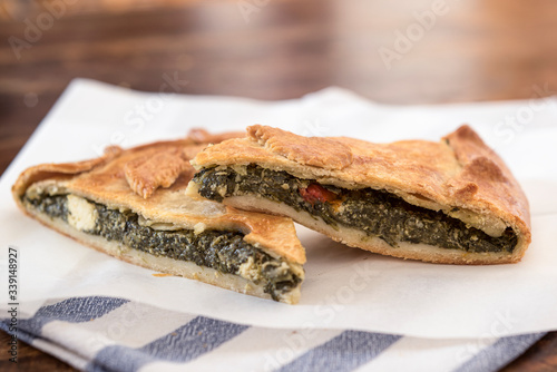 Fototapeta Naklejka Na Ścianę i Meble -  Spinach pie. Traditional Greek spinach pie with  feta cheese feta. Mediterranean Greek food.