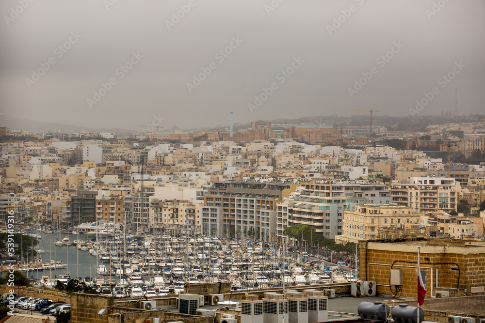 beautiful view of old city and the harbour with colorful boats in Malta