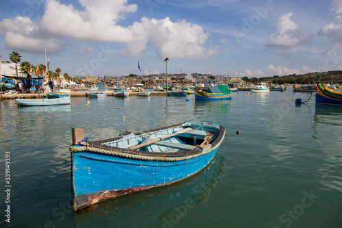 Mediterranean traditional colorful boats luzzu. Fisherman village in the south east of Malta. Early winter morning in Marsaxlokk  Malta.