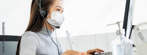 Attractive Asian young woman using computer for video call conference meeting party group working from home during infectious corona virus or covid-19 spread with banner size 