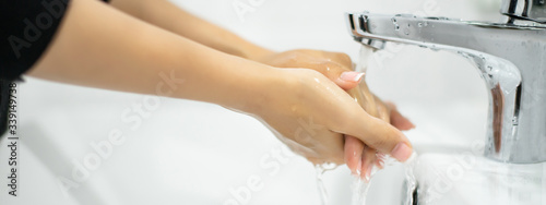 close up at hand washing  in rest room, protection policy for stop break out corona virus or covid 19 spread in banner size for website template