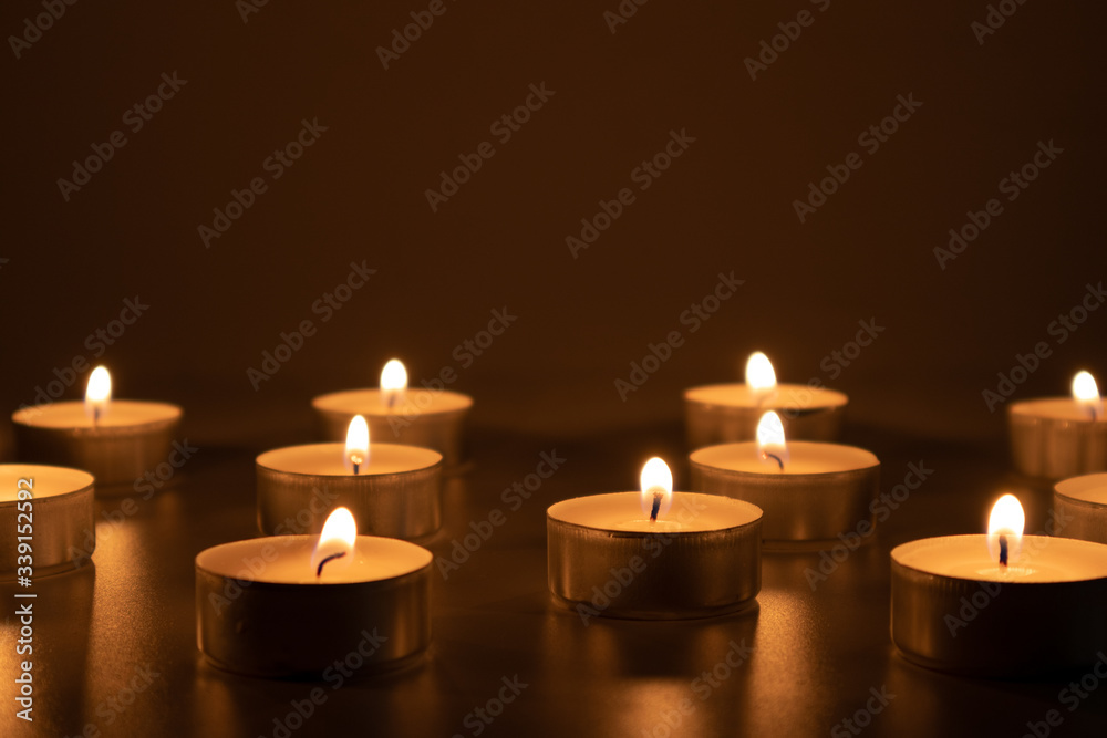 Candles burning in the darkness, devotional and religious image