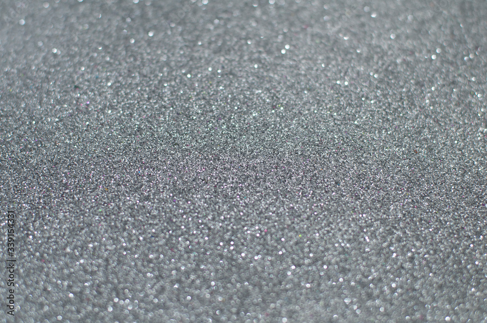 Silver glitter texture abstract background. Shiny glowing colors. Concept of high-tech, elegance, glamour or industry.