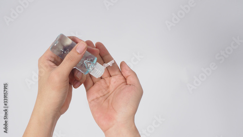 Hands is holding alcohol hand gel on white background.