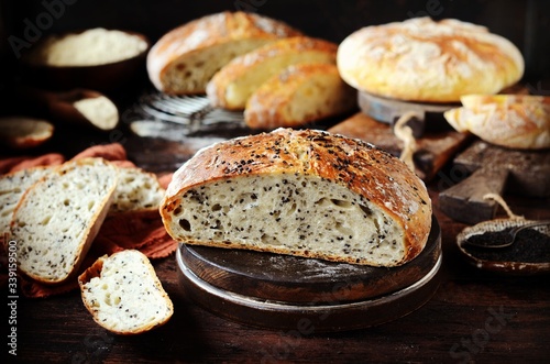 Homemade bread assortment: corn, with sesame seeds and chia seeds on a dark wooden background. rustic