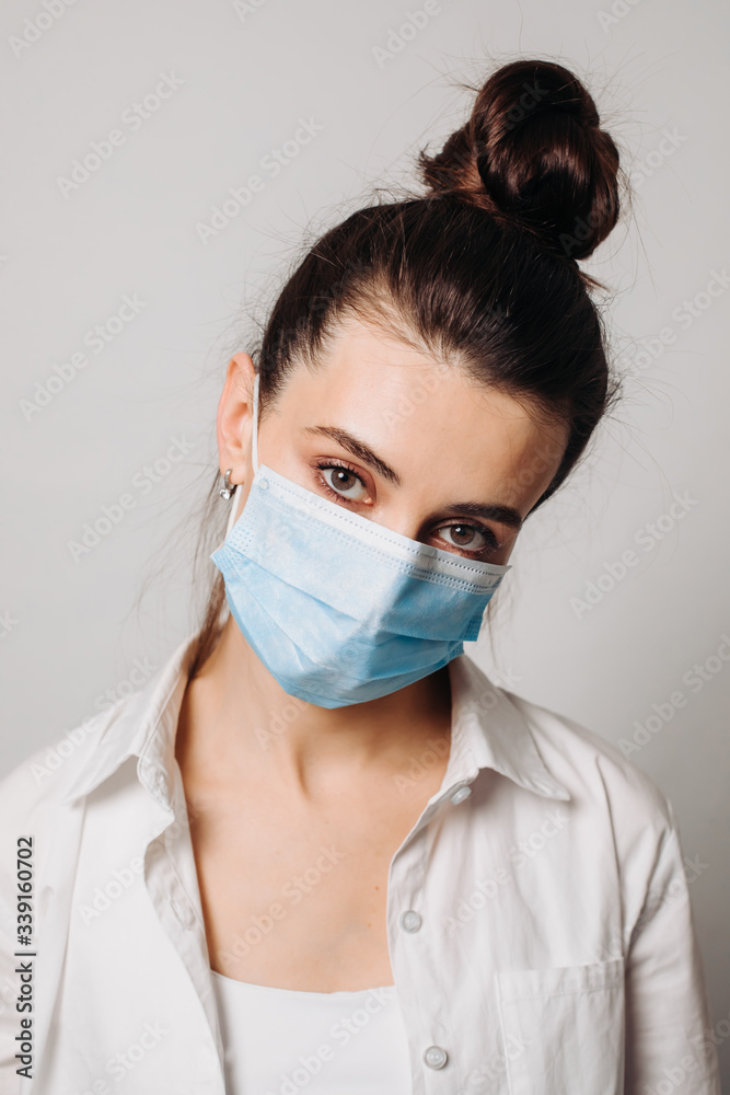 Portrait young woman wearing hygienic mask to prevent infection isolated on white background. Portrait young woman wearing hygienic mask to prevent infection isolated on white background.