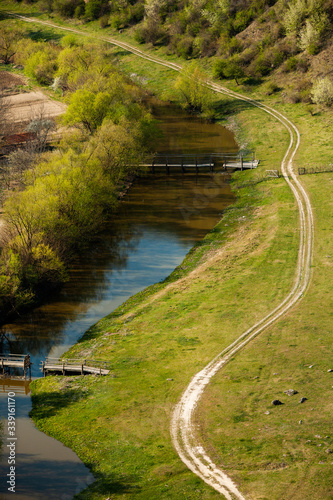 Beautiful spring landscape in Republic of Moldova. Green landscape. Spring Nature. Park with Green Grass and Trees. Travel in Europe. Field with blooming tree and rocks.