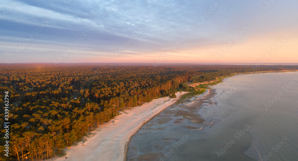 Aerial view on the desolated early morning surise colored sand beach and forested landscape in Võsu resort town in Lahemaa national park, Estonia