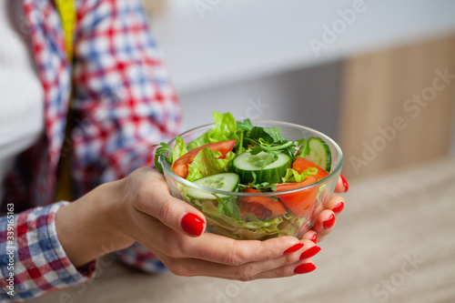 Woman holding salad in her hands for healthy lifestyle.