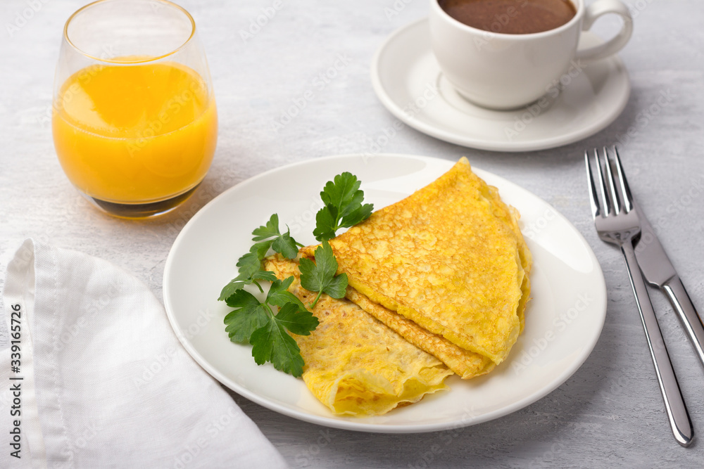 Keto breakfast high-fat low-carb, pancakes without flour and nuts, ketocoffee (bulletproof) with coconut oil, freshly squeezed orange juice on a light gray background