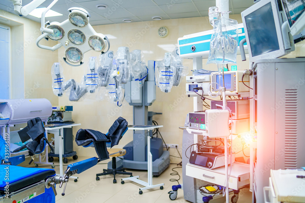 Surgical room in hospital with robotic technology equipment, machine arm surgeon in futuristic operation room. Minimal invasive surgical innovation, medical robot surgery with endoscopy Surgical room in hospital with robotic technology equipment, machine arm surgeon in futuristic operation room. Minimal invasive surgical innovation, medical robot surgery with endoscopy