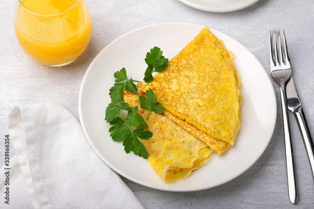 Keto breakfast high-fat low-carb, pancakes without flour and nuts, freshly squeezed orange juice on a light gray background