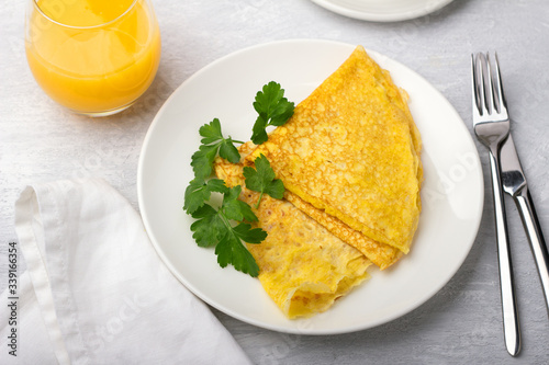 Keto breakfast high-fat low-carb, pancakes without flour and nuts, freshly squeezed orange juice on a light gray background