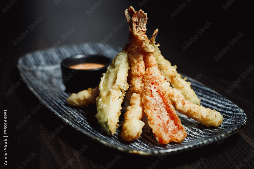 King Prawn Tempura - Japanese dish , battered deep fried seafood - Tiger Prawns . Served with sauce King Prawn Tempura - Japanese dish , battered deep fried seafood - Tiger Prawns . Served with sauce