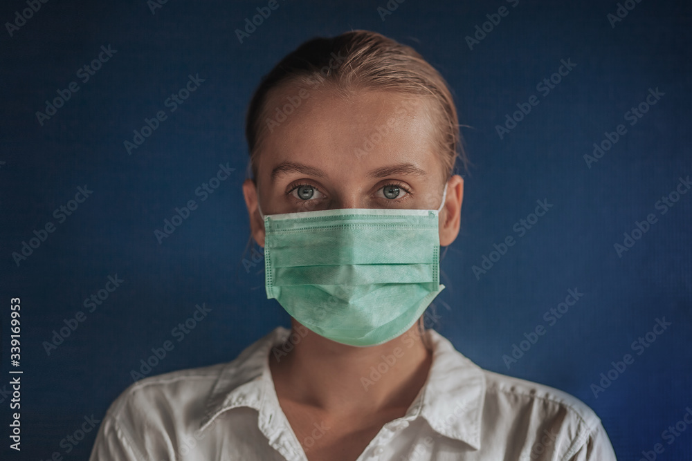 girl in a medical mask on a dark blue background
