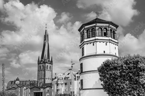 The tower of St. Lambertus basilica and Schlossturm, the palace tower,  the only remnant of the Dusseldorf castle in Burgplatz, Dusseldorf, North Rhine Westphalia, Germany photo