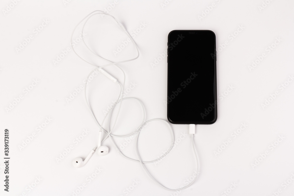Creative flat lay photo of workspace desk with earphones and mobile phone Creative flat lay photo of workspace desk with earphones and mobile phone