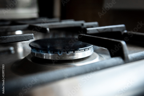 Kitchen stove cook. Kitchen gas cooker with burning blueflames fire propane gas.