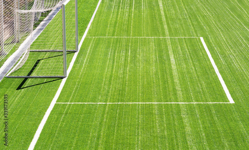 Empty football stadium with goalposts and green turf grass