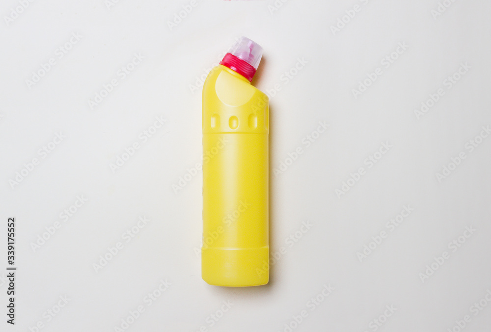 yellow bottle with detegrent on colored paper background