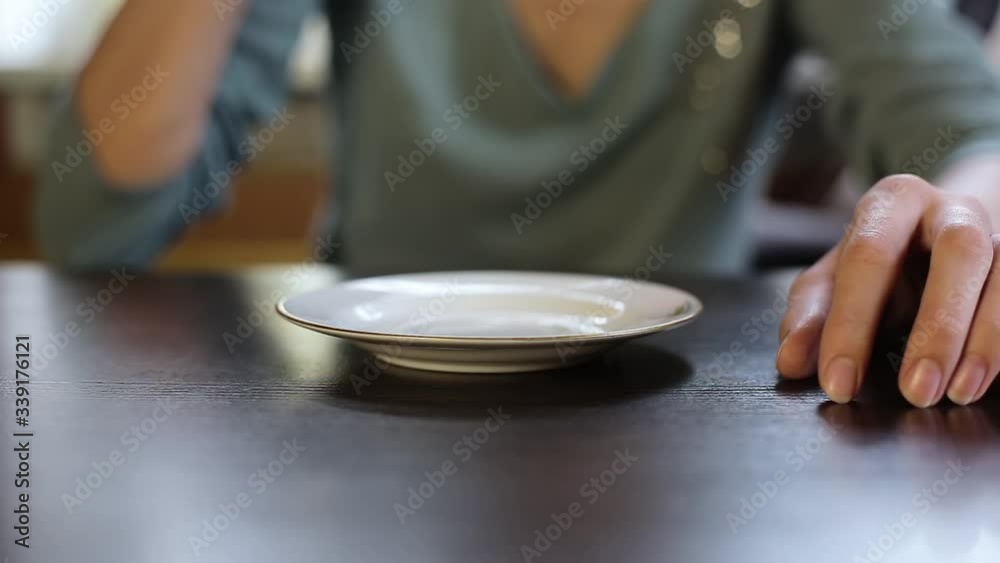 The girl in the cafe raises a Cup of coffee and drinks The girl in the cafe raises a Cup of coffee and drinks