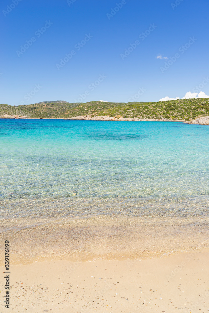 Beautiful sandy beach and crystal clear water at Agia Dynami beach on Chios island, Greece.